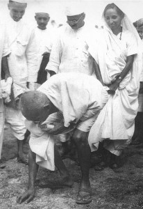 Gandhi picking up salt at the end of the march. Both men and women took part.